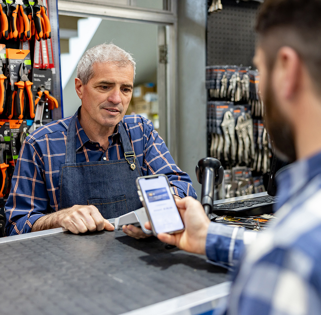 Shopper making a payment in a auto store