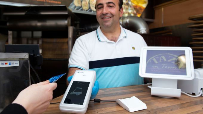 Man taking a payment in with a card machine
